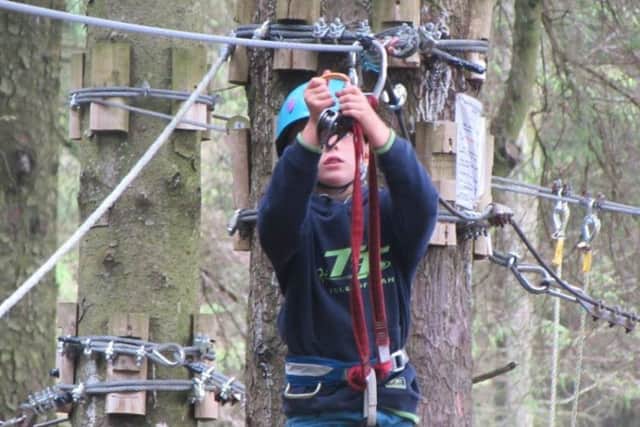 Will connecting himself to the zip wire at Ape Mann Adventure Park.