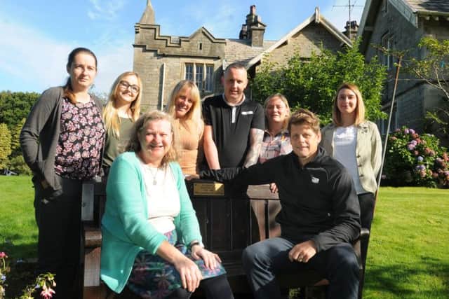LANCASTER  19-09-16
Staff celebrate the ten year anniversary of Littledale Hall Thearapeutic Community, LHTC, for addiction and recovery, Littledale, Lancaster.
from left, Emma Bland, Jess Birchall, Annie Huntington, Amanda Atkinson, David Marshall, Margaret Burrett, Keith Robertson and Jessica Baldwin, sat on the bench in memory of Walter Lyon, who inspired LHTC.