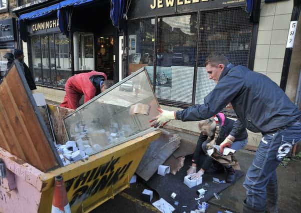 Members of the Gregg family fill a skip with ruined contents of their business, Cunningham Jewellers on Chapel Street, Lancaster, after the December 2015 floods.  PIC BY ROB LOCK 7-12-2015