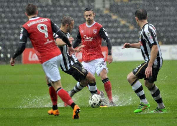 Michael Rose attempts to play a pass as the rain comes down at Meadow Lane. Picture: B&O PRESS PHOTO