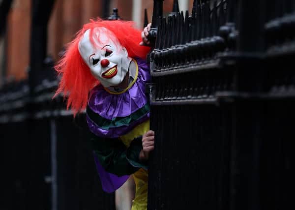 POSED BY MODEL

A person wearing a clown costume in a street in Liverpool. The "killer clown" craze has continued to spread across the UK with one force dealing with 14 reports in 24 hours