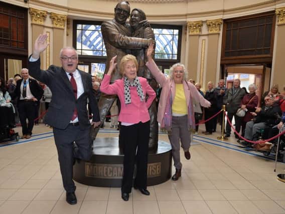 Eric Morecambe's son Gary, his widow Joan and daughter Gail strike his famous pose as they unveil the new Morecambe and Wise statue in Blackpool.