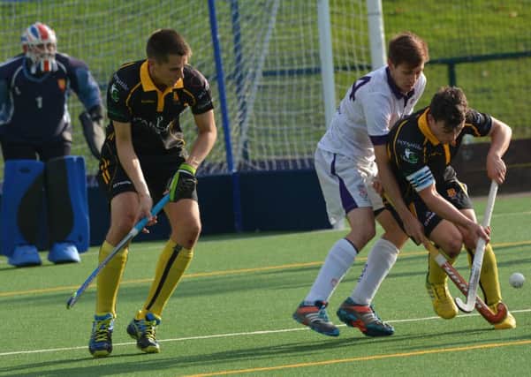 Lancaster and Morecambe Hockey Club's Mens 1s defenders Andy Crabtree and captain Joey Davidson look to halt a Durham attack.