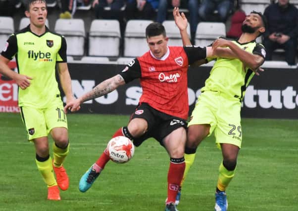 Cole Stockton battles to keep hold of possession against Exeter.