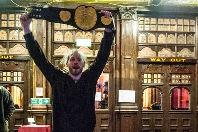 King Ryan Grayson celebrates in the Winter Gardens with the championship belt.