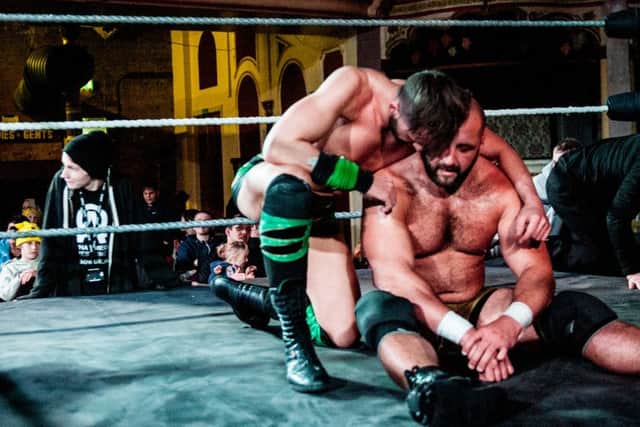 Emotions ran high afterwards as Joey Hayes consoled his friend on his defeat. Hayes and Stixx had been having a classic match for the championship until Grayson intervened. Photo by Tony Knox.