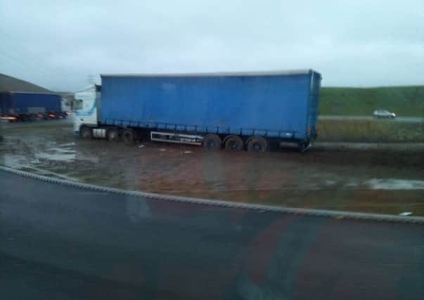 A lorry came off The Bay Gateway and got stuck in the mud on a roundabout on Wednesday morning. Photo by Alec Hurst.