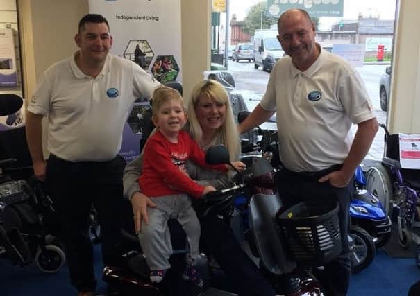 Noah and his mum Shelly with Cumbria Mobility sales director Steve Wright (left) and MD Steve Cornwell (right).