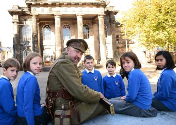 Pupils from Moorside School in Lancaster took part in the Recommissioned project. Here they are pictured with Peter Donnelly, curator of the Kings Royal Regiment Museum. Photo by Darren Andrews.