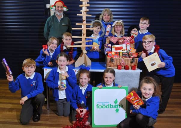 Photo Neil Cross
Annette Smith and Roger Gittings of Morecambe Bay Foodbank and Torrisholme school pupils doing a reverse advent calendar for Christmas.