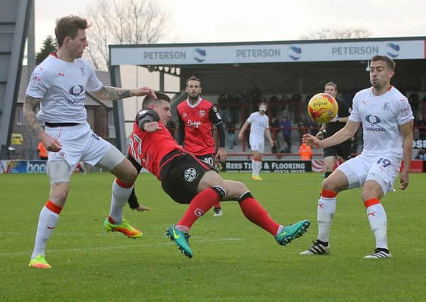 Cole Stockton battles for the ball against Luton.