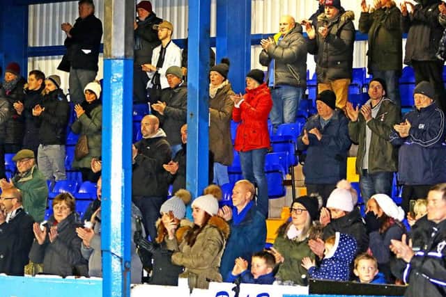 The Lancaster City fans salute Marshall during a minute's applause. Picture: Tony North