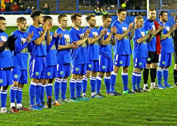 Lancaster City's players take part in a minute's applause for Neil Marshall ahead of their 4-3 win over Mossley on Tuesday night.
