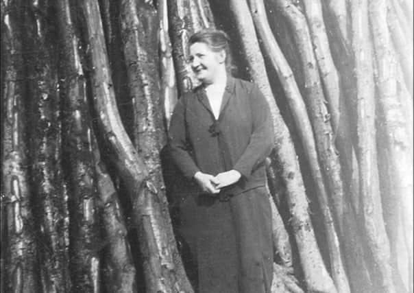 Mary Ann Cissie Dixon at the drying shed in 1920s.