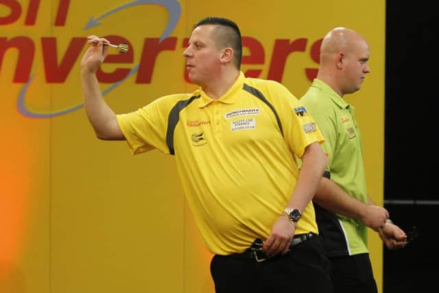 Dave Chisnall in action against Michael van Gerwen. Picture: Lawrence Lustig/PDC