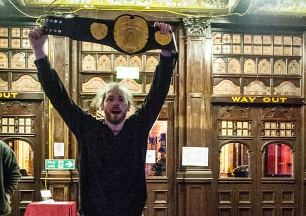 King Ryan Grayson celebrates with the AOW championship belt. Photo by Tony Knox.