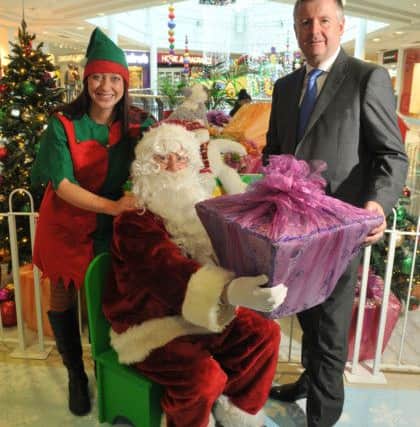Photo Neil Cross
Wilf Holden as Santa with his chief Elf Emma Russ in the Galloway's Grotto at St George's Centre, Preston, with centre manager Andrew Stringer
