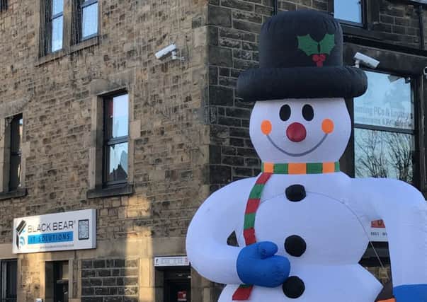One of the 19 foot inflatable figures outside Black Bear Computers in Lancaster, a snowman, was vandalised and has to be repaired before it can be inflated again.