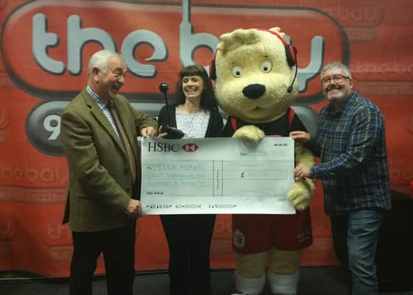 Bob Pound from sponsors Rusland Pool with winner Helen Moran, Bayley the 'Bay Bear' and presenter Tony 'Cooky' Cookson.