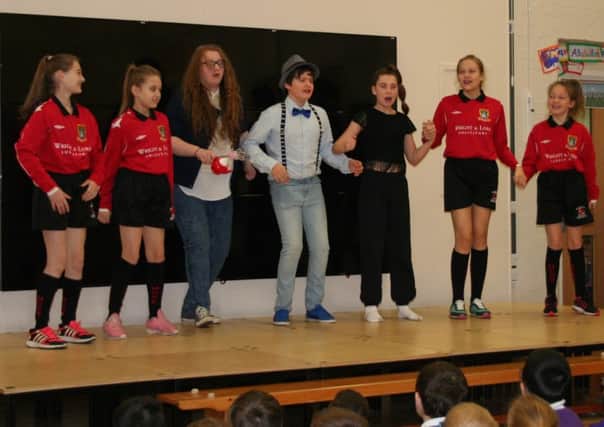 Pupils from Morecambe Community High School performing their play about female Polish students who dream about becoming footballers.