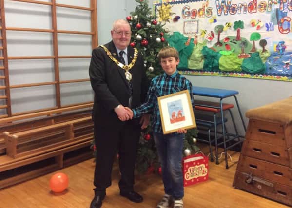 The Mayor of Lancaster and Boaz Hughes with a framed copy of his winning Christmas card design.