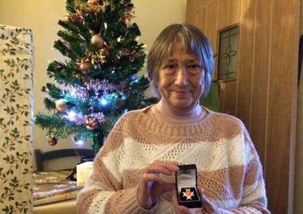 Beryl Swales with Tony's Order of St John award at her home in Lancaster.