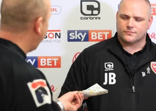 Mark Swindlehurst surprises Jim Bentley with money collected by Morecambe FC fans to pay his disciplinary fine. 

Picture still taken from Morecambe Football Club video.