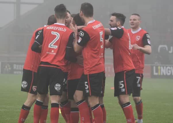 Aaron Wildig, second from right, joins the celebrations for Lee Molyneux's opening goal against Notts County.