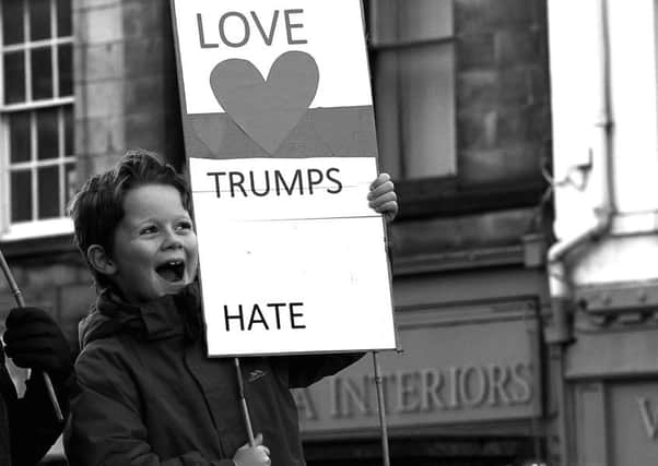 A youngster holding one of the signs in the Lancaster gathering on Saturday.