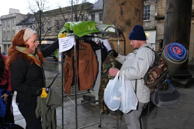 Photo Neil Cross
Anna Hopkinson with the coat rail outside Lancaster library which she has put there to help homeless people