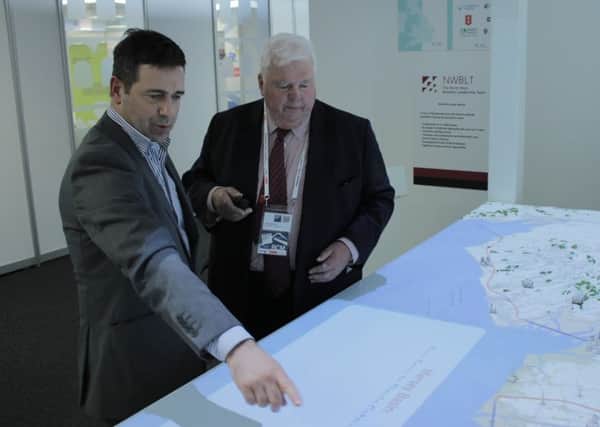 Alan Torevell from North West Energy Squared (right) shows Juergen Maier from the North West Business Leadership team a map of the barrage.