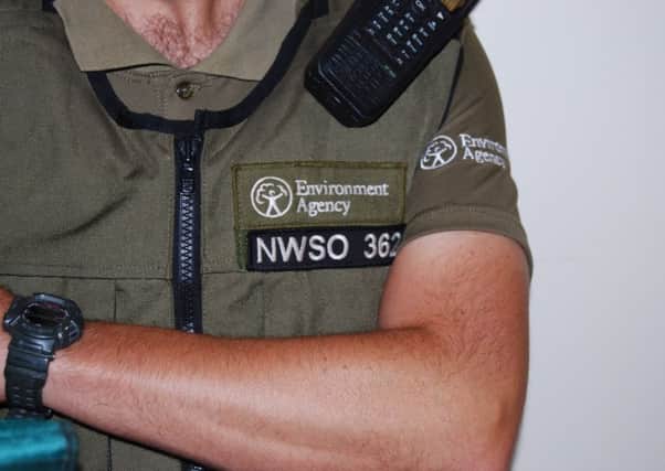 An Environment Agency fisheries bailiff with his badge.