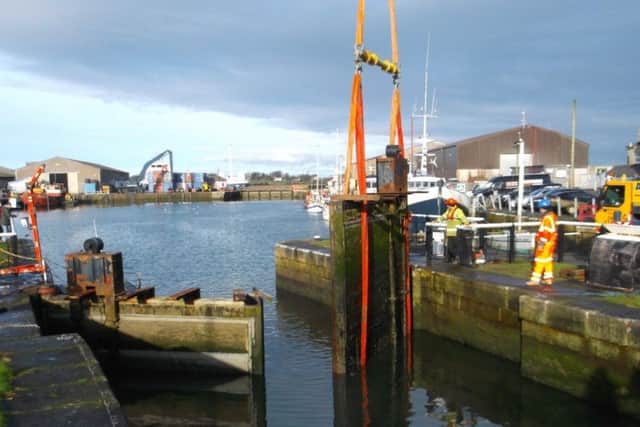 Glasson Dock lock gates being craned out.