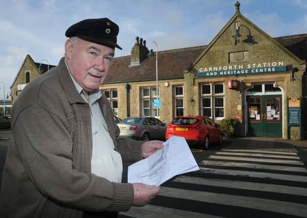 Former volunteer at Carnforth Station Jim Walker, who has been banned from the station following a complaint about him from a member of the public regarding an alleged remark he made.
Jim at the station with a map he has been issued marking the routes around the station he is allowed to follow.  PIC BY ROB LOCK
30-1-2017