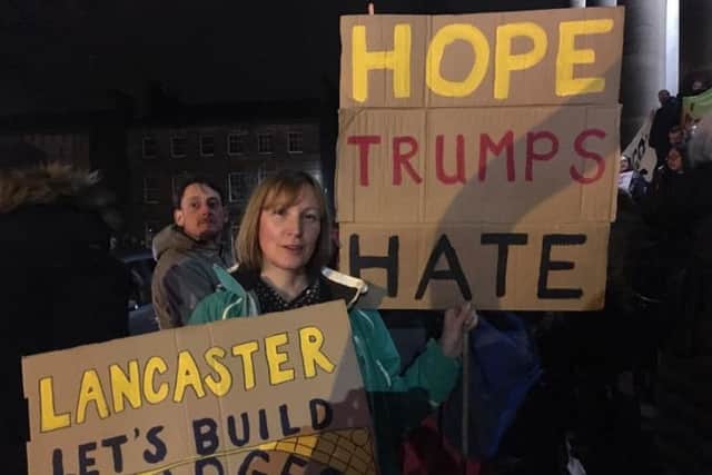 Colette Bain, from Warton, with her signs at the anti-Trump protest in Lancaster.
