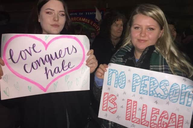 Morgan Hanley and Victoria Skorgevik with their signs at the anti-Trump protest in Lancaster.