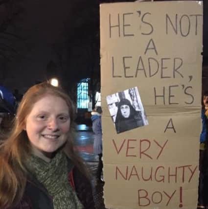 Rachel Evans, 24, from Lancaster, with her sign at the anti-Trump protest in Lancaster.