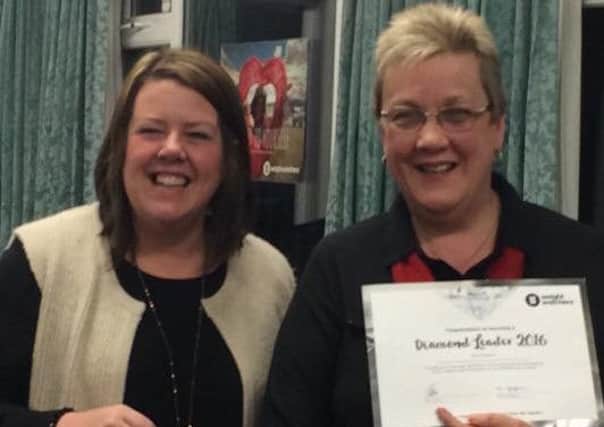 From left Cathy Brotherton receiving her award from area manager Debra Heppell.