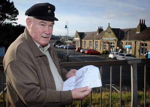 Former volunteer at Carnforth Station Jim Walker, who has been banned from the station following a complaint about him from a member of the public regarding an alleged remark he made.
Jim at the station with a map he has been issued marking the routes around the station he is allowed to follow.  PIC BY ROB LOCK
30-1-2017