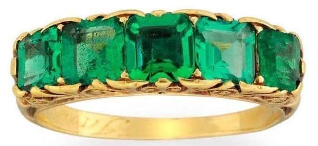 The stolen engagement ring is made of gold and has two emeralds and three garnets.