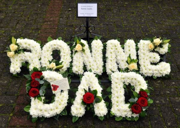 Photo Neil Cross: Floral tributes to Ronne Coyles at his funeral on Tuesday, including one from TV comedian Harry Hill spelling 'Dad'.
