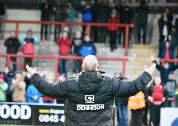 Jim Bentley salutes the Morecambe fans after the win against Cambridge.