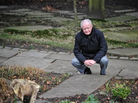 Journalist and author Alan Roby at the grave of Mary Weeton at Thomas the Martyr Church, Upholland, Wigan