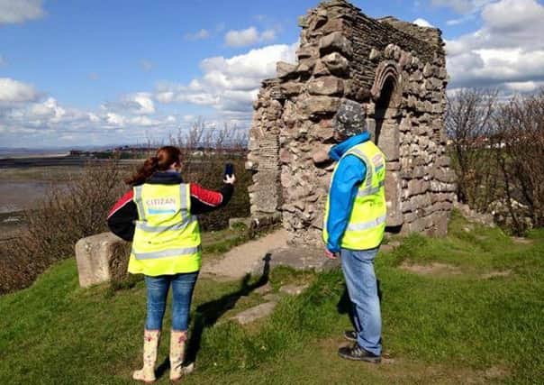 Volunteers investigating and recording the remains of a structure adjoining Rectory Woods, Heysham.