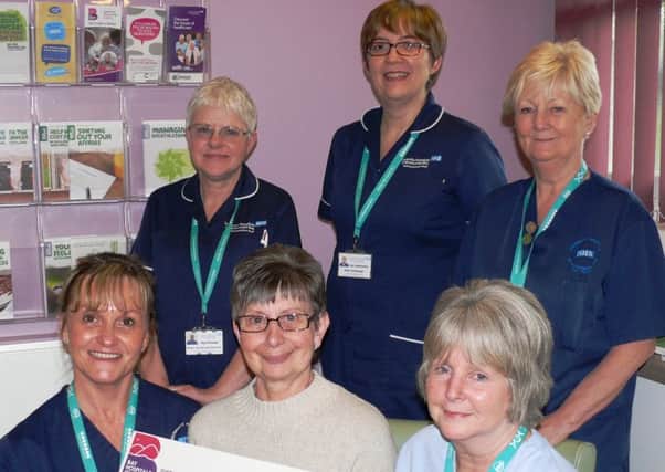 Anne Duncan seated centre in the front row with sister/clinical leader Linda Whitfield (left) and clinical support worker Carol Moore. On the back row, from left is unit manager/lead cancer nurse Sue Procter, sister/unit manager Lyn Lawrenson and sister/clinical leader Janet Rigg.