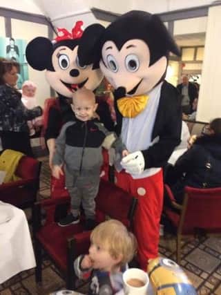 Charlie with Mickey and Minnie Mouse at the Morecambe Bay Hotel, where the fundraising day was held.
