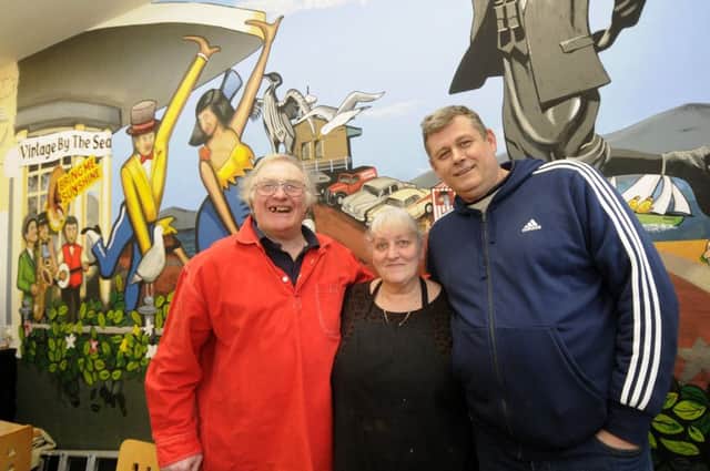 Artist Bob Pickersgill has painted a mural inside The Star Cafe at the Festival Market.  He is pictured with owners Joanne Baxter and Andy Best.