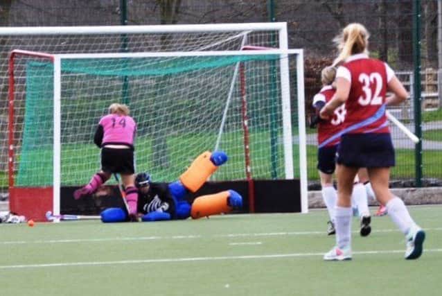 Lancaster 2s goalkeeper Abi Symonds makes a save down to her right.