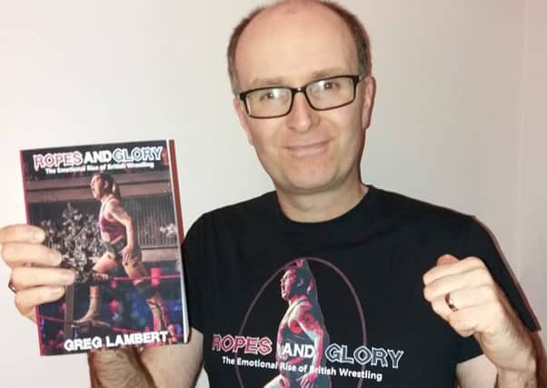 Greg Lambert with his new book about British pro wrestling.