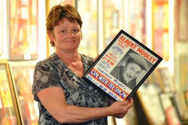 Picture by Julian Brown for the LEP 01/06/15  Debbie Cain, whose grandfather was comedian Albert Modley, pictured with a poster of him from the exhibition of old-time entertainment at the new Morecambe Heritage Centre.